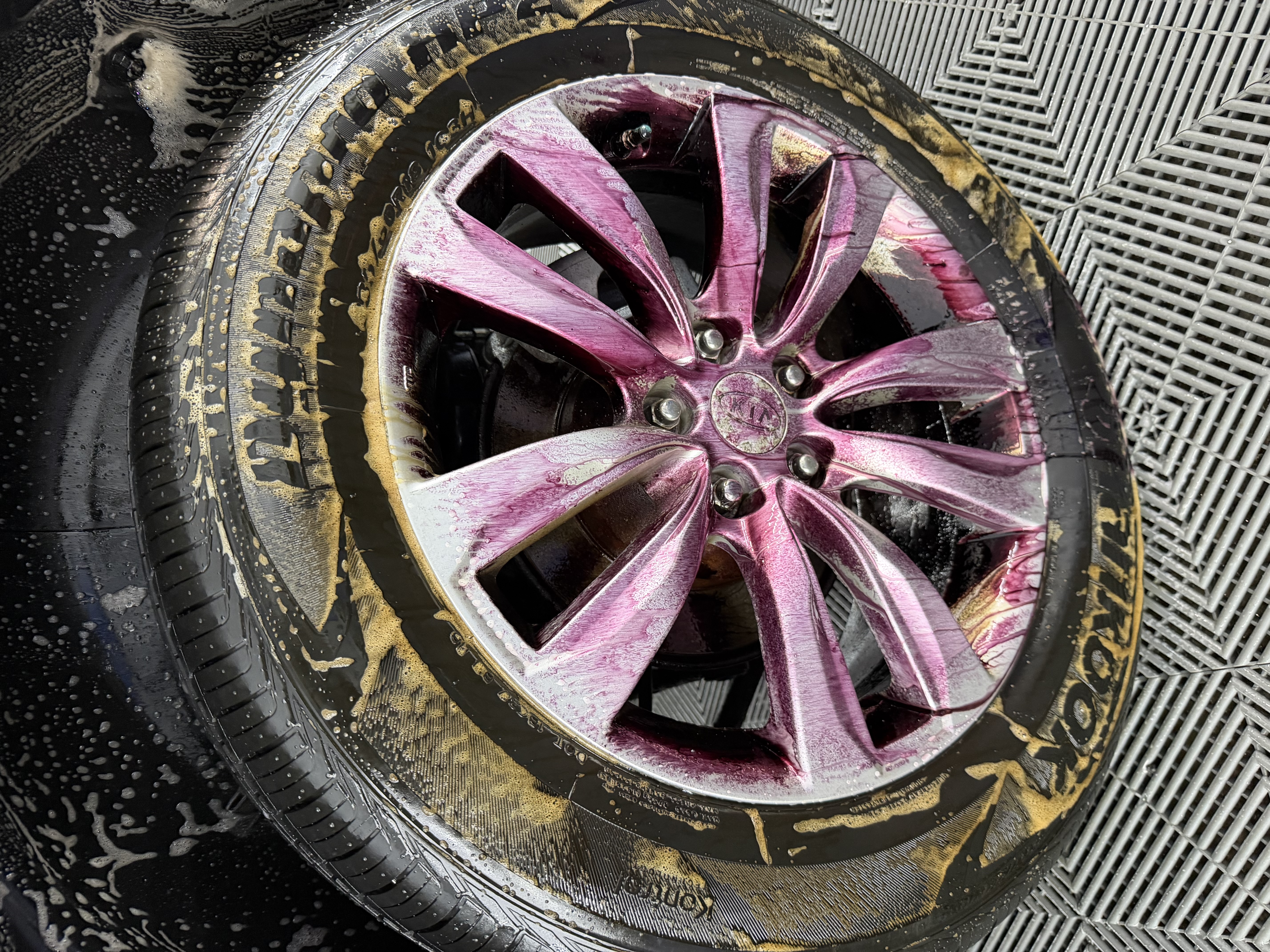 Purple iron remover reacting with contamination on a vehicle wheel