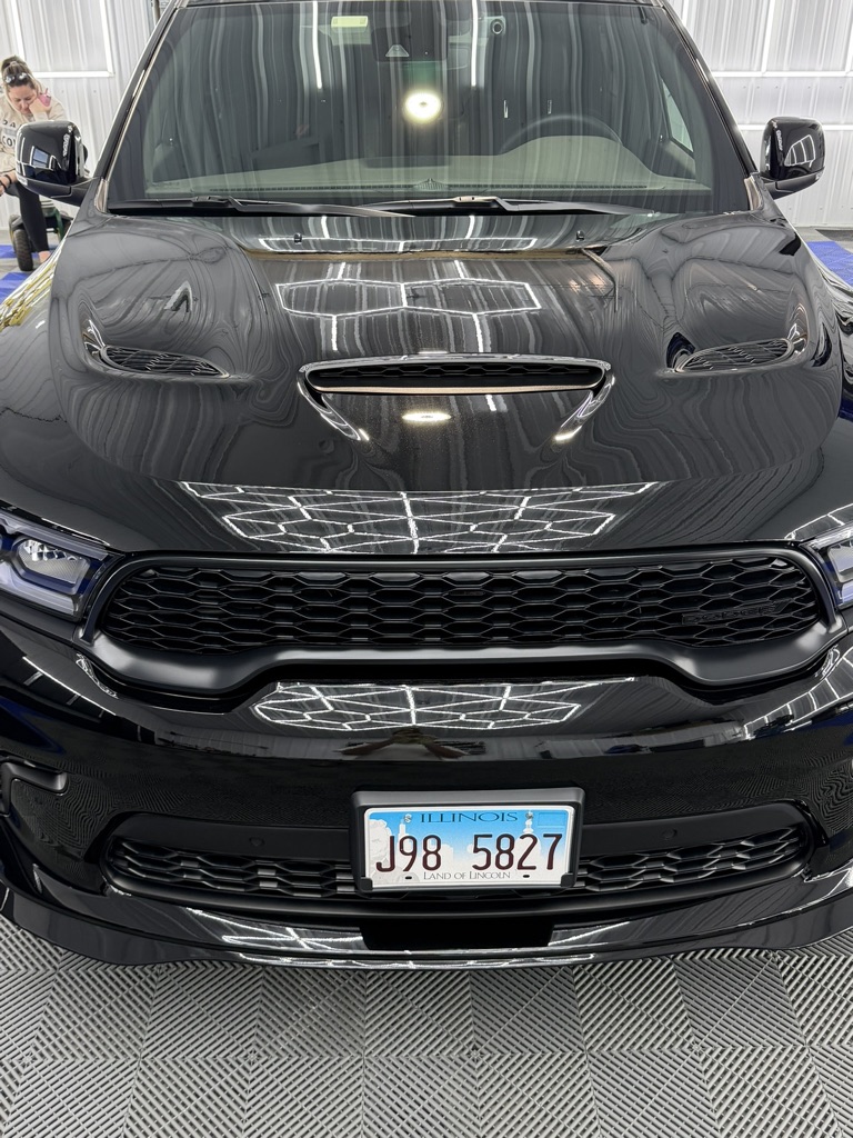 Black Dodge Durango front end with a clear reflective finish after paint correction