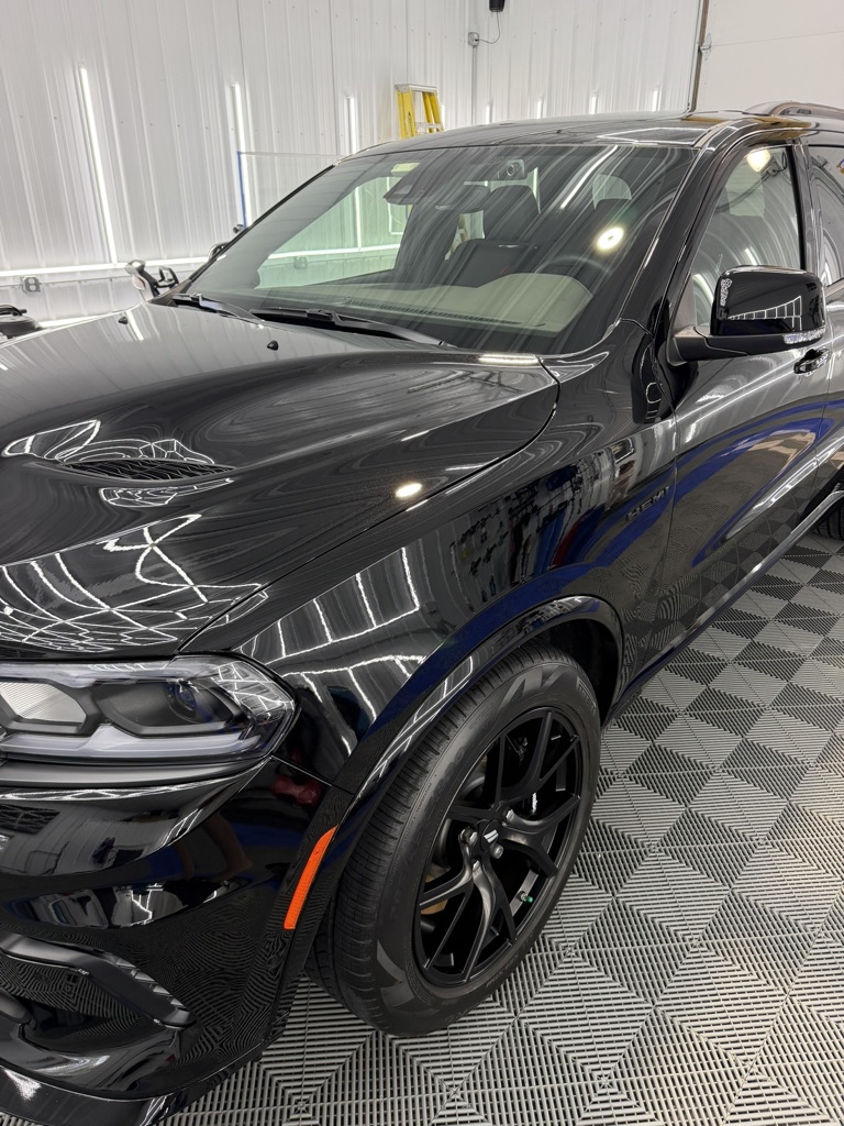 Black Dodge Durango with a deep gloss finish inside the Porter’s Detailing bay in Grant Park, Illinois