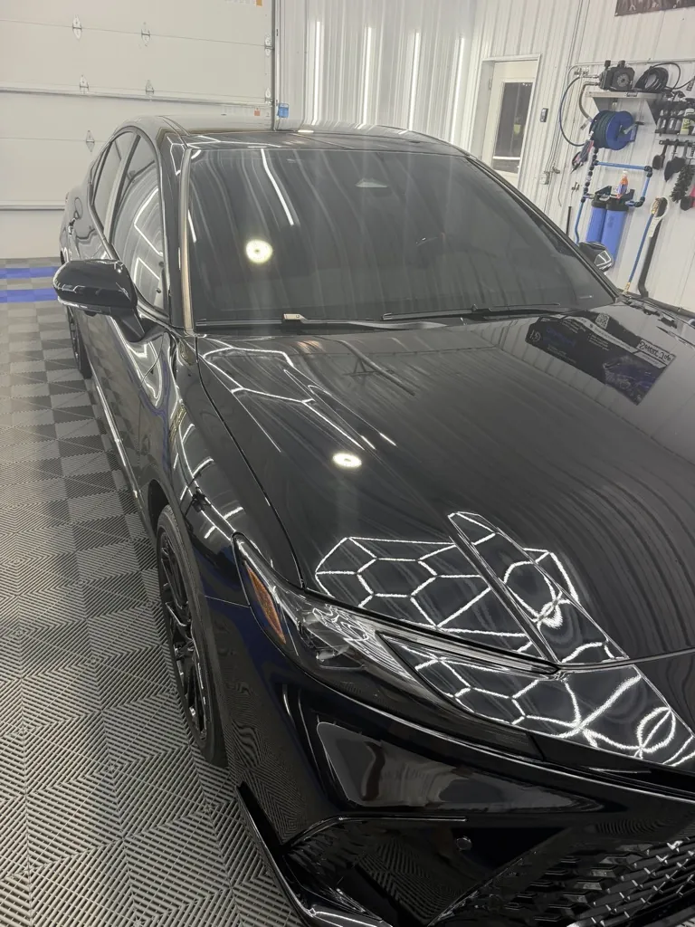 Black sedan with glossy corrected paint